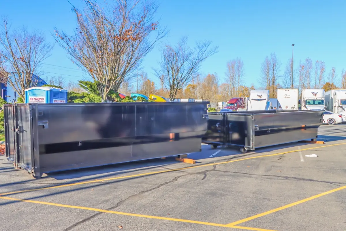 Professional dumpster rental service with roll-off container on residential driveway in Fort Myers Shores